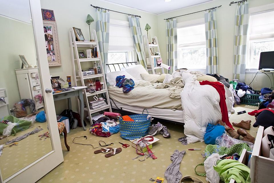 A bedroom overtaken by clutter. Use the following tips to reduce clutter in your home.