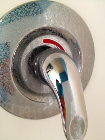 A shower with hard water stain deposits