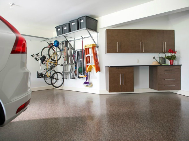 A clean and well organized garage space that utilizes hooks for efficient storage of equipment