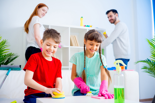 happy family cleaning their living room