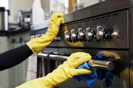 cleaning an exterior oven with gloves on