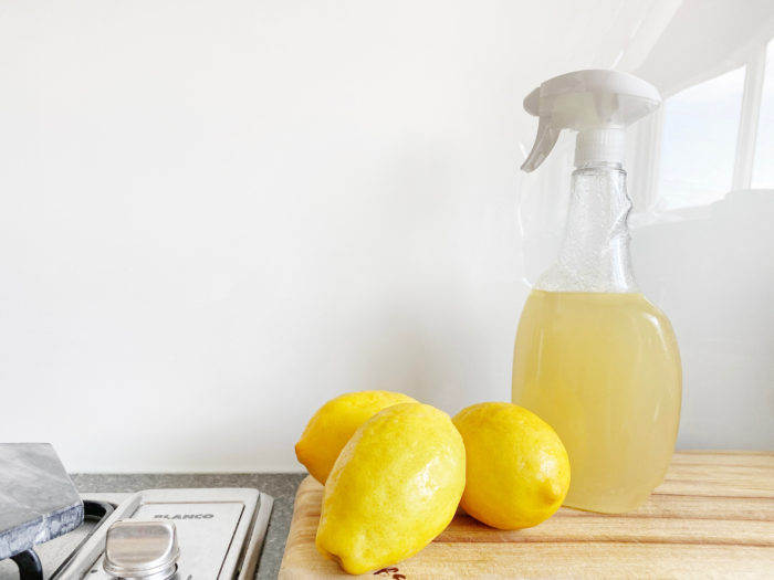 homemade green all purpose cleaner with citrus in a spray bottle
