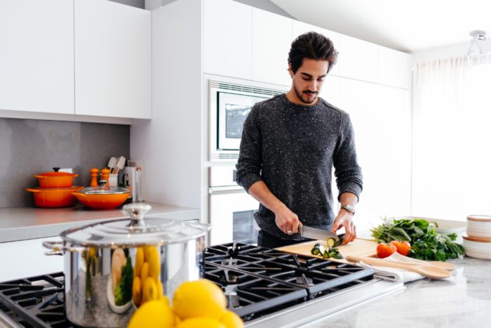 a man prepping a meal to cook in his clean kitchen