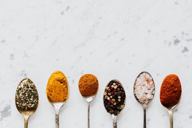 various spices on spoons