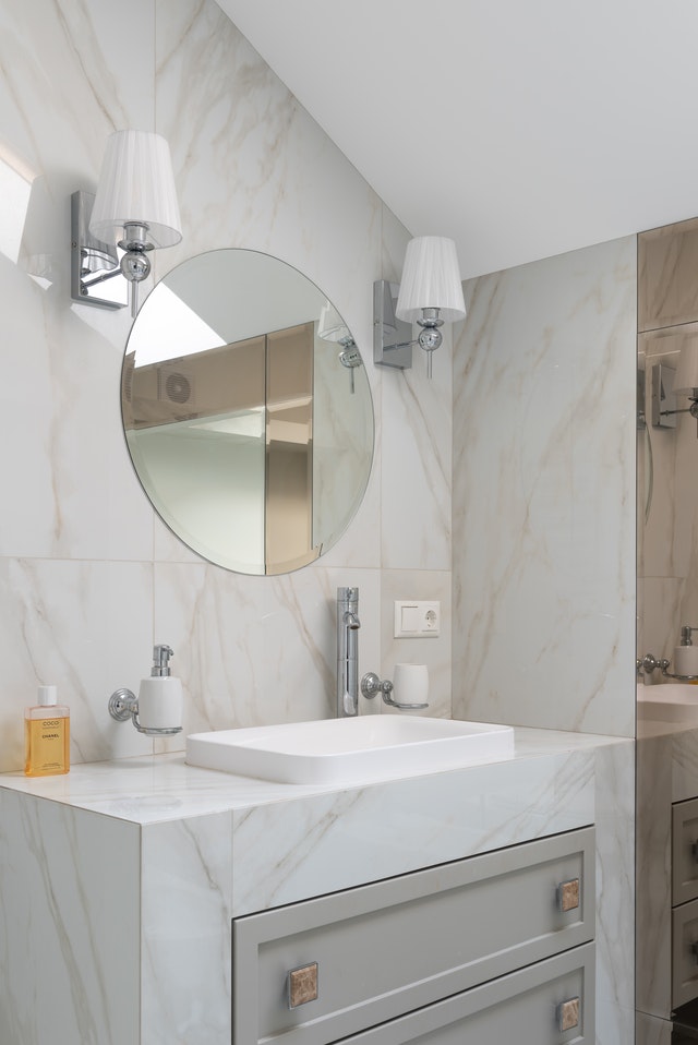 a clean light colored bathroom sink and vanity