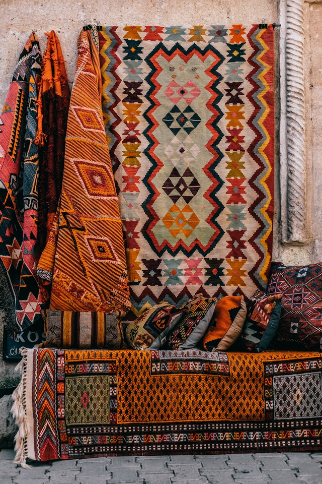 colorful rugs hanging up