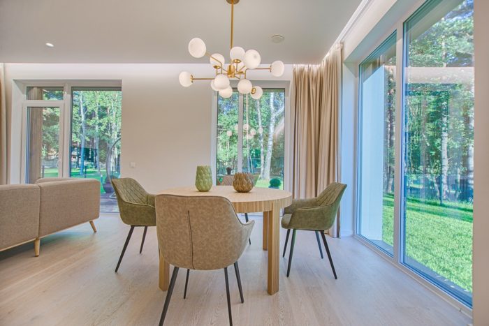 a clean and bright dining room area with large windows