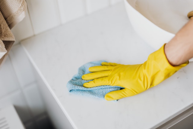 a microfiber cloth to clean a bathroom sink