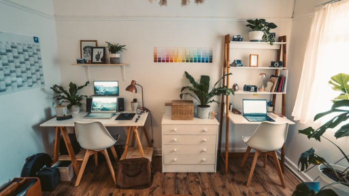 a white colored home office with 2 desk spaces