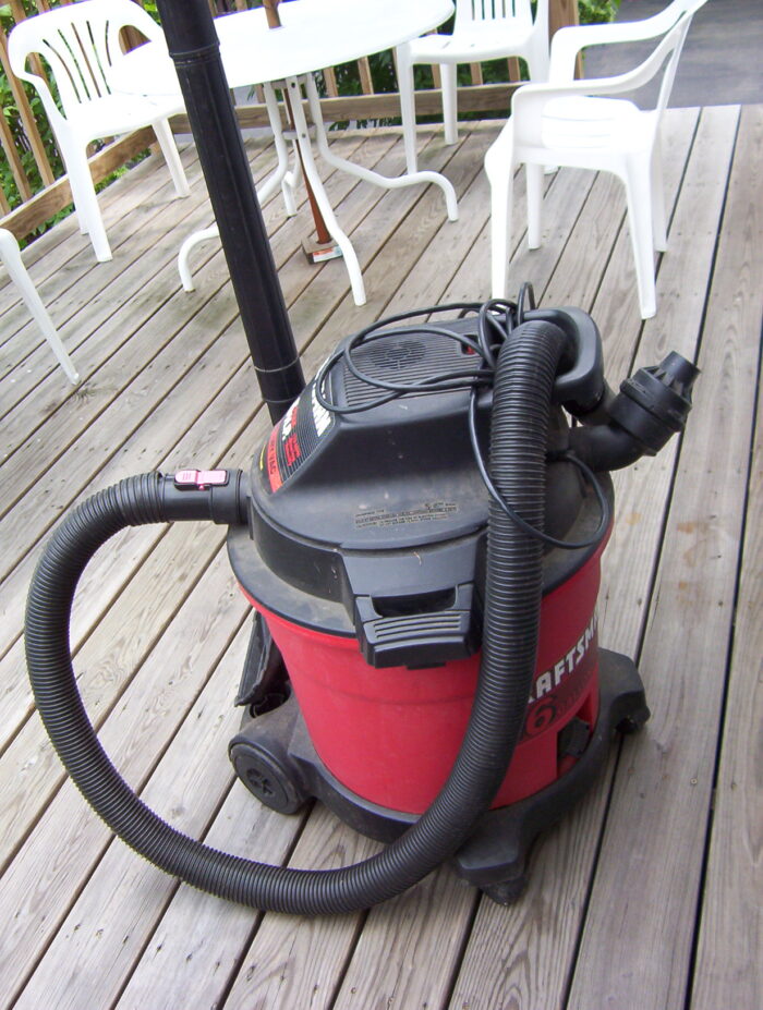 a wet dry vacuum sitting on a deck