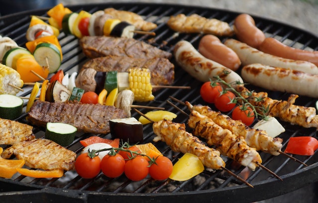 a grill filled with vegetables and meat