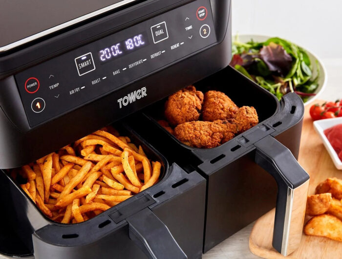 an air fryer basket with french fries and fried chicken