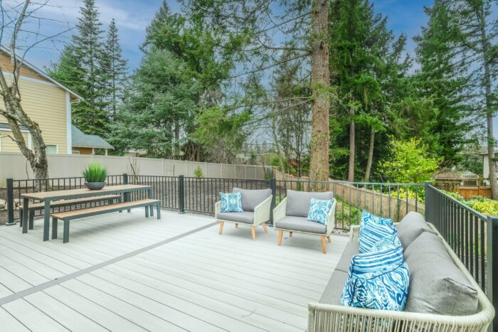 a clean deck with furniture and a picnic table
