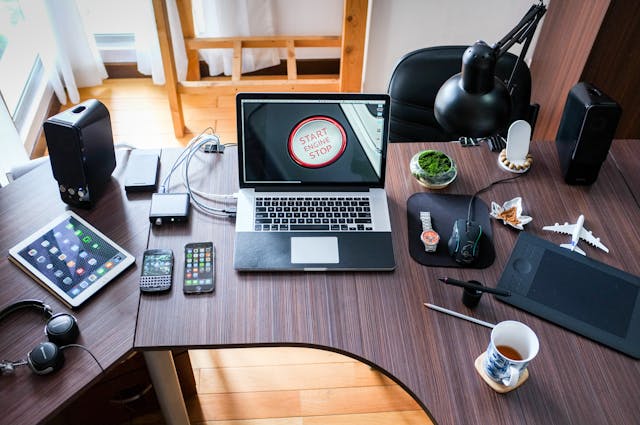 A desk with a computer and other electronics